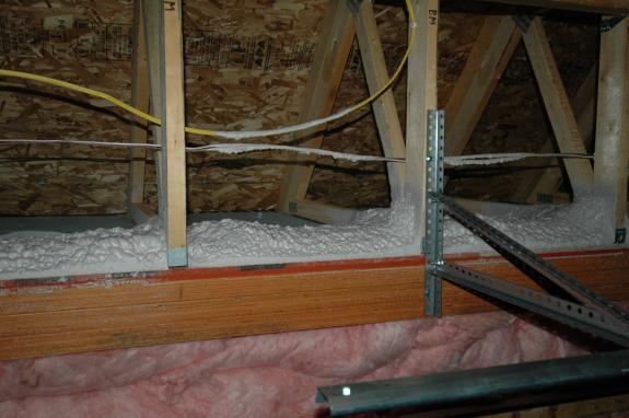 Spray foam insulation on garage beam